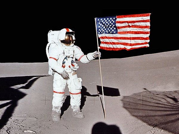 Astronaut Alan Shepard raises the United States Flag on the surface of the moon 